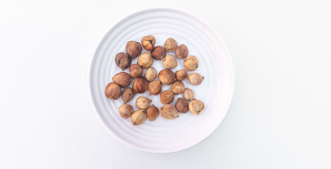 Cardamom, Siam Cardamom or Cardamom on a white plate isolated on white background. Camphor dried seeds. Dried Herb Spice. Top view