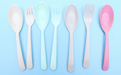 Utensils set colorful fork, and spoon isolated on blue background