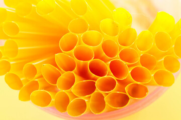 Close up Colorful holes in yellow straws isolated on yellow background, straws that are the same color as the background. Deep of field hole photo