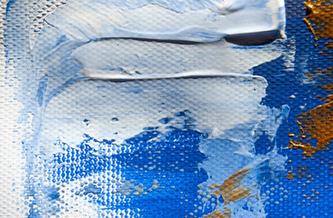 Abstract layers of blue, white, and golden acrylic paint on canvas, forming a vibrant and textured artistic background.