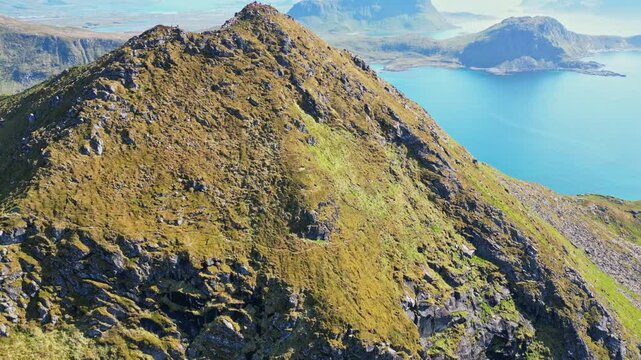 Aerial view of breathtaking Uttakleiv beach with rugged mountains and pristine coastline, Leknes, Norway.