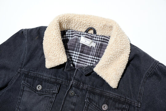 kent, uk, 01.01.2023 A rustic aviator fashionable black denim jacket topman medium sherpa borg collar checked lining. Fur lined collar jacket coat. Streetwear city casual clothing.