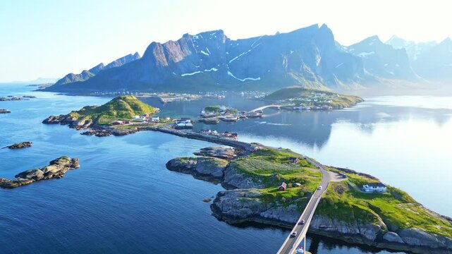 Aerial view of a picturesque fishing village with a bridge surrounded by majestic mountains and a tranquil fjord, Hamnoy, Norway.