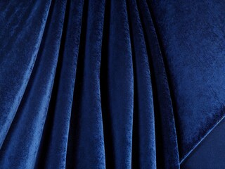 Fototapeta premium Deep blue velvet fabric with elegant folds.