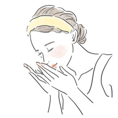 顔に手を当ててスキンケアをする女性の上半身