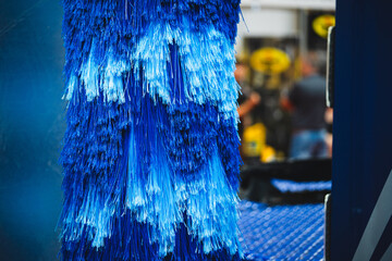 Blue brush washer at an automatic carwash station