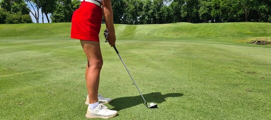 Professional woman golfer wearing sport wear teeing golf in golf tournament competition at golf course for winner