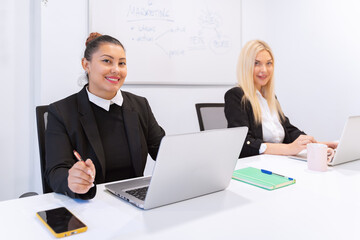 Professional businesswomen smiling while working in the office. Business concept.