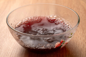 Liquid red jelly is poured and dissolved in a bowl for solidification. Preparation of gelatin desserts.