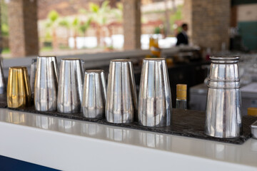Professional bar equipment arranged neatly on a counter in a contemporary bar setting