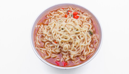 A bowl of spicy Gekikara ramen instant noodles with chili pieces isolated on white background