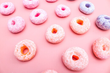 Dry pong donut cake, flat lay, background of round colorful cereal. isolated pink background. Typical Indonesian light snack