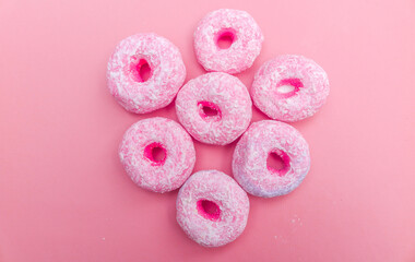 Dry pong donut cake, flat lay, background of round colorful cereal. isolated pink background. Typical Indonesian light snack