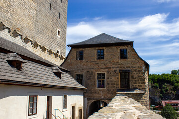Obraz premium Fairytale, medieval, stone castle Kost with windows and arches. Built on a rock with green trees in the Czech Republic