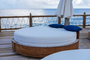Relaxing outdoor seating by the ocean on a sunny day at a tropical destination