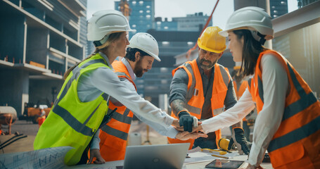 Professional Team of Civil Engineers and Construction Managers Putting Hands Together After a...