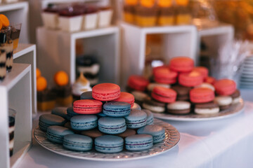 Macaroon tower or pyramid and cupcakes on sweet dessert table