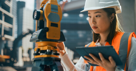 Portrait of a Beautiful Japanese Female Engineer Working with Optical Measuring Equipment. Young Asian Woman Standing Outdoors, Using a Theodolite for Planning and Developing a Real Estate Project