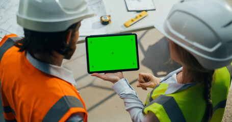 Technical Inspector and Construction Manager Using a Tablet with Green Screen Mock Up Template....