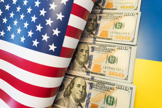 The war in Ukraine, financial assistance from usa. dollars against the background of the Ukrainian flag and american flag.