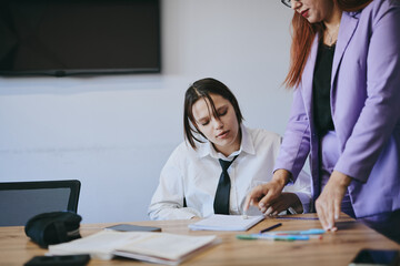 Obraz premium Schoolgirl and teacher have a lesson in the office, private lessons, distance learning