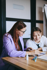 Schoolgirl and teacher have a lesson in the office, private lessons, distance learning