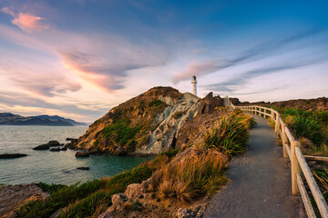 Evening sky over Castlepoint Lighthouse or Holiday Light and upper staircase on Wairarapa coast at...