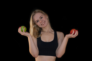 Smiling Fit Girl Holding Green and Red Apples on Black Background