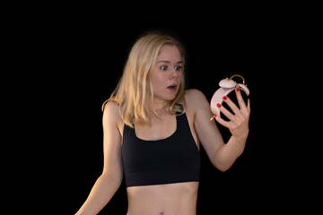 Shocked Fit Girl Holding Alarm Clock, Surprised by Time