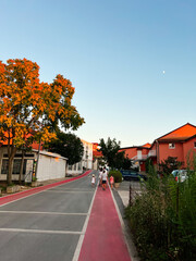 Family walking on quiet neighborhood street at sunset. Medjugorje, Bosnia and Herzegovina.