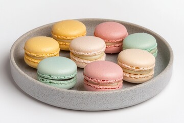 Obraz premium Outline sketch and guideline concept, A colorful assortment of macarons arranged neatly on a gray plate, showcasing pastel hues of yellow, green, pink, and blue.
