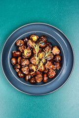Warm roasted chestnuts served on a plate