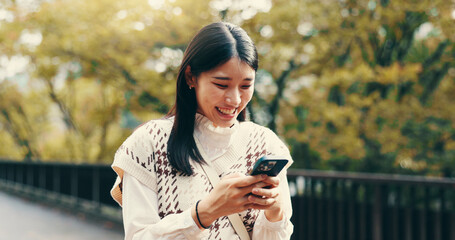 Japanese woman, laughing and phone in street for online networking, dating app and funny text message. Person, smartphone and happy for social media meme, notification and browsing internet on bridge