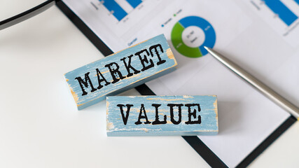 Concept word Market Value on wooden blocks. Business and We are moving concept
