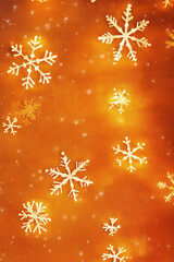 Christmas vertical background with glowing snowflakes on orange canvas