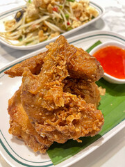 Crispy fried chicken with dipping sauce.