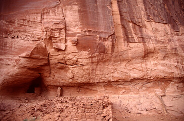 An old residential building built on a red rock mountain