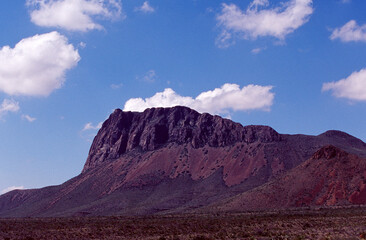 Red rock mountain and blue sky with clouds