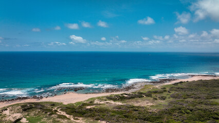 Breathtaking coastal view from Longpan Park showing the vibrant blue ocean and sandy beach