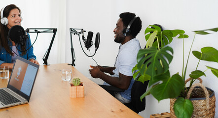 Female host speaker making a podcast interview during live streaming - Technology trends and...