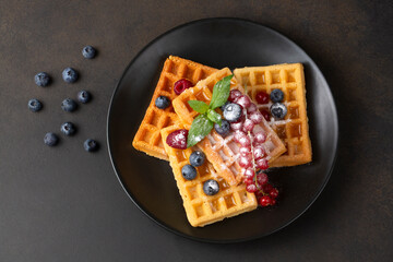 Delicious fresh baked belgian waffles with berries and fruit