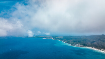 Aerial view of Jialeshuei shows vibrant blue waters and lush Taiwan coastline