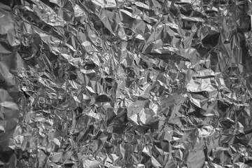 Processed collage of shiny metal silver gray foil crumpled packaging material texture