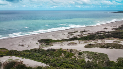 Expansive coastline of Taiwan showcasing sandy beaches and gentle waves on a clear day