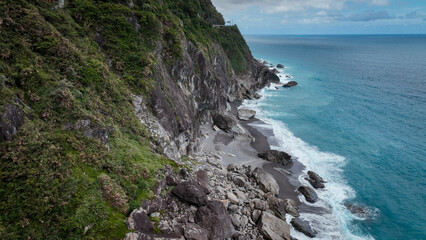 Stunning coastal view at Taiwan with rocky cliffs and gentle waves on a cloudy day