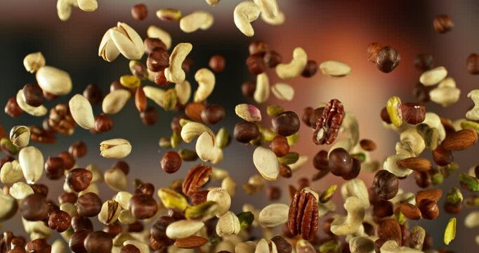 Super Slow Motion of Flying Nuts Mix. Abstract Blur Interior on Background. Filmed on High Speed Cinema Camera , 1000fps. Camera in Motion.