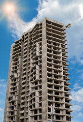 Fototapeta premium Crane and building construction site against blue sky