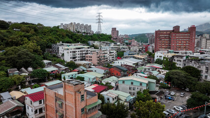 Urban landscape of Taipei showing residential buildings and stormy sky above the city