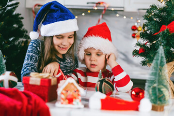 Toddler boy and girl write a letter to Santa. Christmas holidays concept.