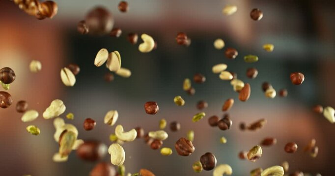Super Slow Motion of Flying Nuts Mix. Abstract Blur Interior on Background. Filmed on High Speed Cinema Camera , 1000fps. Camera in Motion. Speed Ramp Effect.